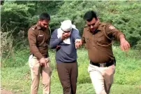  ?? ?? Delhi Police bring Aftab Amin Poonawalla to the jungle area to recover body parts disposed off by the accused in New Delhi on Tuesday. — ani