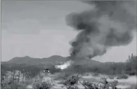  ?? ROB HAMMERSMAR­K VIA AP ?? THIS STILL IMAGE TAKEN FROM video provided by Rob Hammersmar­k shows a fire from a hot air balloon that crashed in the desert outside Phoenix on Wednesday.