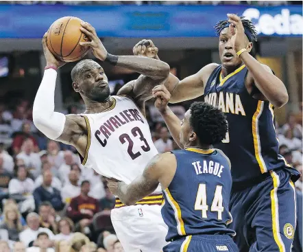  ?? — THE ASSOCIATED PRESS ?? LeBron James of the Cavaliers is swarmed by Jeff Teague and Myles Turner of the Indiana Pacers during the opening game of their first-round NBA playoff series on Saturday in Cleveland. James scored 32 points as the Cavaliers squeaked by the Pacers 109-108.