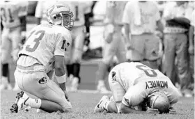  ?? STAFF FILE PHOTO ?? FSU kicker Dan Mowrey buries his head after missing a 39-yard field goal that would have tied the score against Miami. The missed attempt became known as Wide Right II. Mowrey, today an attorney in St. Augustine, offered advice to Michigan punter Blake...