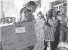  ??  ?? Joann Marcus, left, cheers as she listens to the Broward School Board’s emergency meeting Wednesday in Fort Lauderdale, Fla.