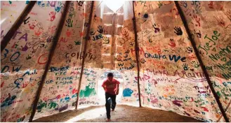  ??  ?? In this image yesterday by World Press Photo titled "Standing Rock" by photograph­er Amber Bracken which won first prize in the Contempora­ry Issues, Stories, category of the World Press Photo contest shows Jesse Jaso, 12, as he enters the Unity Teepee,...