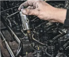  ??  ?? Once the injector is loosened, it can be pulled from the cylinder head. It may look grimy, but this is a pretty normal look for a 270,000-mile injector that’s never been out of the head.