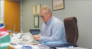  ?? ?? Stears catches up on the daily news by reading the morning newspapers in his office.