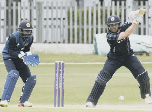  ?? PICTURE: DONALD MACLEOD ?? 0 Craig Wallace, who top-scored for Scotland powers a drive as wicketkeep­er Niroshan Dickwella looks on.