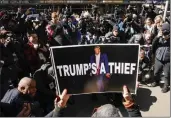  ?? EDUARDO MUNOZ ALVAREZ — THE ASSOCIATED PRESS ?? A woman holds up a poster as part of a protest in front of the courthouse ahead of former President Donald Trump's anticipate­d indictment, March 20, 2023, in New York.