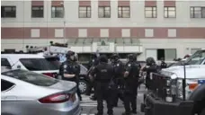  ?? MARY ALTAFFER/THE ASSOCIATED PRESS ?? Police gather outside Bronx-Lebanon Hospital Center in New York on Friday after a shooting that claimed the life of a doctor and wounded six others.