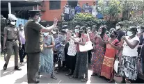  ??  ?? Family members of inmates gather demanding to know the condition of their relatives outside the Mahara prison complex following an overnight unrest in Sri Lanka, on Monday