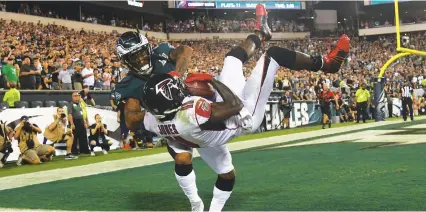  ?? (Reuters) ?? PHILADELPH­IA EAGLES cornerback Ronald Darby (left) pushes Atlanta Falcons receiver Julio Jones out of bounds on the final pay of the game in the defending-champion Eagles’ dramatic 18-12 victory over the Falcons in the NFL season opener on Thursday night.