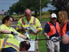  ?? MARIAN DENNIS — MEDIANEWS GROUP ?? Area state representa­tives and PennDOT employees were hard at work as they cleaned up trash from the side of the road near Route 422 in Limerick.