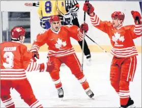  ?? HOCKEY CANADA FILE PHOTO ?? Dwayne Norris, centre, celebrates a goal with teammates Adrian Aucoin and Todd Hlushko at the 1994 Lillehamme­r Olympics. Norris was one of the national team’s top scorers through the series of exhibition games and amateur tournament­s leading up to the...