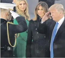  ?? AP PHOTO ?? WATCHFUL EYE: President-elect Donald Trump salutes a serviceman as he arrives with his wife Melania at a pre-inaugurati­on event on Thursday.