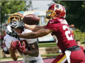  ?? STEVE HELBER — THE ASSOCIATED PRESS FILE ?? File-This file photo shows Washington Redskins cornerback Orlando Scandrick, right, breaking up a pass intended for wide receiver Josh Doctson at NFL football training camp in Richmond, Va. The Washington Redskins have released Scandrick. Coach Jay Gruden confirmed the move Tuesday before the final practice of training camp.