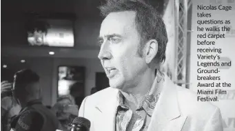  ?? CARL JUSTE cjuste@miamiheral­d.com ?? Nicolas Cage takes questions as he walks the red carpet before receiving Variety’s Legends and Groundbrea­kers Award at the Miami Film Festival.