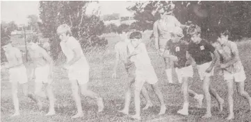  ??  ?? Little Athletics at Warragul got underway for 1971 last night, when about 100 little athletes took part in a twilight meeting at the Warragul Technical School oval.
Pictured above, the field in the boys walk sets out on an 800-metre journey around the oval after getting the signal from the starter, Mr Dick Auklema.
At left, tiny-tot B. Miller, of the Warragul West Club leaps into the sand in the broad jump event under the watchful eye of officials Mrs Marie Cumming and Mr Alan Cochrane.