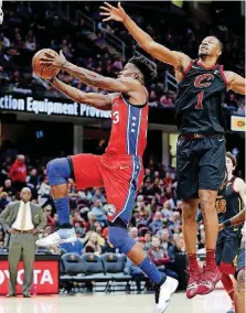  ?? [AP PHOTO] ?? Philadelph­ia 76ers’ Jimmy Butler scores past Cleveland Cavaliers’ Rodney Hood during the second half Sunday in Cleveland.