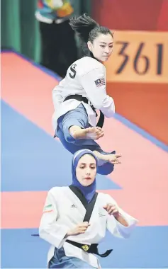  ?? — Bernama photo ?? Khim (top) in action during the women’s individual poomsae semi final match in 2018 Jakarta-Palembang Asian Games.