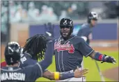  ?? ERIC GAY — THE ASSOCIATED PRESS ?? The Braves’ Marcell Ozuna celebrates after scoring during the third inning in Game 3of the National League Division Series against the Miami Marlins on Thursday in Houston.