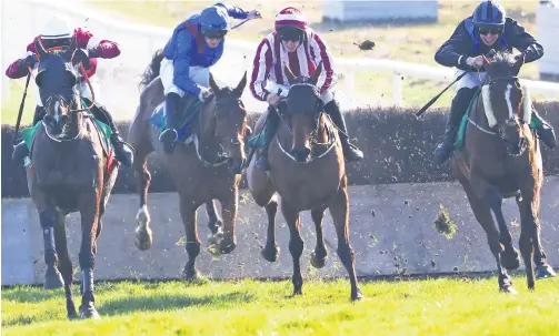  ?? PETER MORRISON ?? Flashback: Ben Harvey, in the red and white stripes, on his way to winning the Randox Ulster Grand National at Downpatric­k riding Space Cadet in the last NI meeting before the Covid-19 shutdown