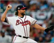  ??  ?? Atlanta starting pitcher R.A. Dickey delivers in the first inning of Saturday’s game against the San Diego Padres, in Atlanta. The Braves won 4-2.