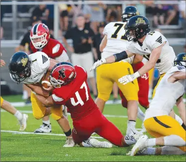  ?? NWA Democrat-Gazette/ANDY SHUPE ?? Farmington’s Josh Stettmeier (47) tackles Prairie Grove’s Cade Grant during the Cardinals’ 27-7 victory over the Tigers at Cardinal Stadium. Stettmeier is a home-schooled athlete who played organized football for the first time as a junior last season for Farmington.