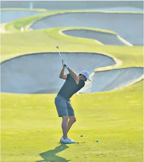  ??  ?? Warm-up: Rory Mcilroy plays in the pro-am prior to this week’s event in Dubai