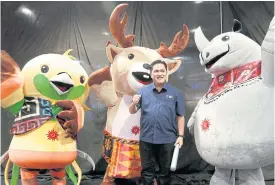  ??  ?? Chief organiser Erick Thohir poses with the Asian Games mascots.