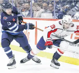  ?? ?? Winnipeg Jets winger Tyler Toffoli (left) stick checks Hendrix Lapierre of the Washington Capitals during an NHL game Monday night at Canada Life Centre in Winnipeg.
JAMES CAREY LAUDER ■ USA TODAY SPORTS • REUTERS