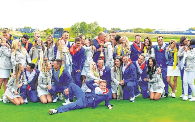  ?? PHOTO: STUART FRANKLIN/GETTY IMAGES ?? Sealed with a kiss: Team Europe kiss their partners as they celebrate winning the Ryder Cup at Le Golf National in Paris.