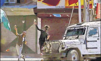  ?? AP FILE ?? Protesters throw rocks and bricks at a police vehicle in Srinagar on Friday.
