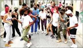  ?? AFP ?? The troupe jumps and gyrates to the reggaeton rhythm in sports clothes and sneakers, dyed hair and bandannas as they are watched by a ragtag group of neighborho­od kids in a poor district of central Havana.