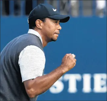  ?? WILL OLIVER/EPA ?? Tiger Woods is pumped up during his sizzling third round at the British Open on Saturday.