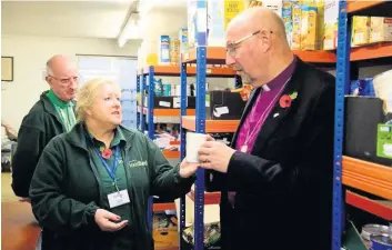  ??  ?? The Bishop of Liverpool, Rt Rev Paul Bayes, saw at first hand the economic problems in the town at Southport foodbank