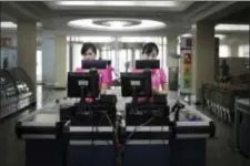  ?? WONG MAYE-E — THE ASSOCIATED PRESS ?? Cashiers stand at checkout counters waiting to serve customers at the Potonggang department store in Pyongyang, North Korea. Three generation­s into Kim Jong Un’s ruling dynasty, markets have blossomed and a consumer culture is taking root.