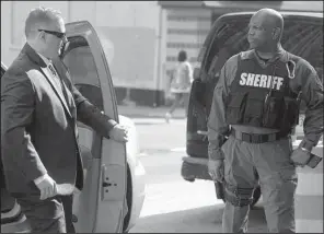  ?? AP/STEVE RUARK ?? Officer Garrett Miller (left), one of six members of the Baltimore Police Department who were charged in the death of Freddie Gray, arrives for court Wednesday, where he heard all charges had been dropped.