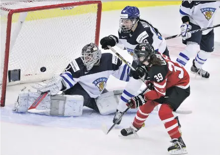  ?? CLAUDIO BRESCIANI/ GETTY IMAGES ?? Emily Clark, 19, the youngster player on the Canadian team, scores on goalie Eveliina Suonpaa of Finland during their IIHF Women’s Hockey World Championsh­ip Pool A match in Malmo, Sweden, on Tuesday. The 6- 2 win moved Canada into the semifinals.