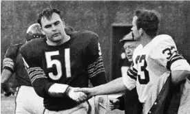  ?? Photograph: Charles Harrity/AP ?? Dick Butkus (No 51) shakes hands with Jim Grabowski of the Green Bay Packers, 1967.