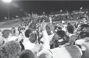  ?? ALONZO J. ADAMS/SPECIAL TO THE OKLAHOMAN ?? Holland Hall holds up the championsh­ip trophy after defeating Lincoln Christian for Class 3A football title at Wantland Stadium in Edmond on Dec. 11.