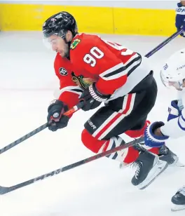  ?? SWEDA /CHICAGO TRIBUNE CHRIS ?? Chicago center Tyler Johnson skates for a loose puck at the United Center on Oct. 27.