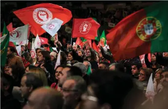  ?? — AFP photo ?? Supporters cheer as Socialist party leader Pedro Nuno Santos delivers a speech during a rally in Porto ahead of the general elections.