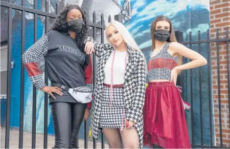  ?? CHARLES FOX/THE PHILADELPH­IA INQUIRER ?? Designer Jacqueline City, center, with two of her fashions, modeled by Alana Edwards, left, and Madison Hodges.