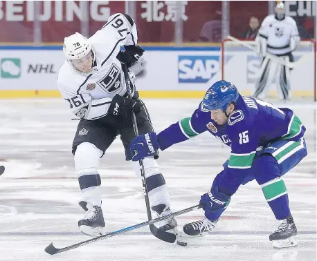  ?? — AP FILES ?? Jonny Brodzinski of the Kings is harassed by Canucks grinder Derek Dorsett during pre-season action. Dorsett is coming off a back injury and ‘hungry to prove’ he can still play his usual gritty game.