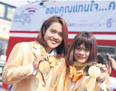  ??  ?? Sopita Tanasan, left, and Sukanya Srisurat with their 2016 Olympic gold medals.