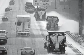  ?? GERRY BROOME/AP ?? Vehicles navigate hazardous roads along Interstate 85/40 as a winter storm moves through the area in Mebane, N.C., Sunday.