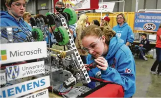  ?? Carlos Osorio photos / Associated Press ?? Valerie Alexander, 14, works on her team's robot at the FIRST Championsh­ip in Detroit. “I would definitely like to see more girls interested in this kind of thing,” she says.