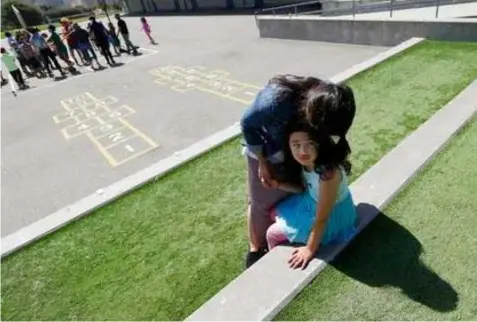  ?? (AP Photo/Jeff Chiu) ?? In this Tuesday, July 11, 2017 photo, Sandra Collins, executive director and founder of enGender, hugs her child Scarlett at the Bay Area Rainbow Day Camp in El Cerrito, Calif. Gender experts say Rainbow’s rapid growth reflects what they’re seeing in...