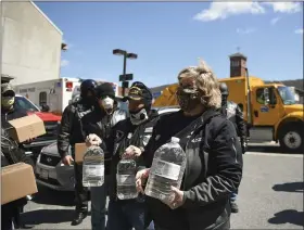  ?? LAUREN A. LITTLE — MEDIANEWS GROUP ?? Members of the Berks County chapter of the Blue Knights Law Enforcemen­t Motorcycle Club and the Jarrett Yoder Foundation donate hand sanitizer and disinfecta­nt to law enforcemen­t April 22at City Hall. Yoder’s mother, Diane Yoder of Rockland Township, is in the foreground.