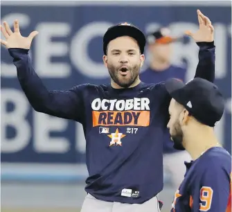  ??  ?? Astros second baseman Jose Altuve, left, jokes around with teammate Marwin Gonzalez during batting practice in L.A. on Monday on the eve of the World Series.