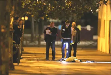  ??  ?? French police at the scene of the attack in the streets of Paris. — AFP photo