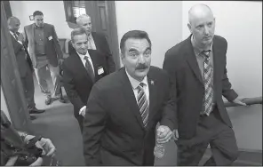  ?? AP/MEL EVANS ?? New Jersey Democratic Assembly Speaker Vincent Prieto (center) is accompanie­d by Horizon Blue Cross Blue Shield of New Jersey Chairman and CEO Bob Marino (right) at the Statehouse on Monday, in Trenton, N.J.